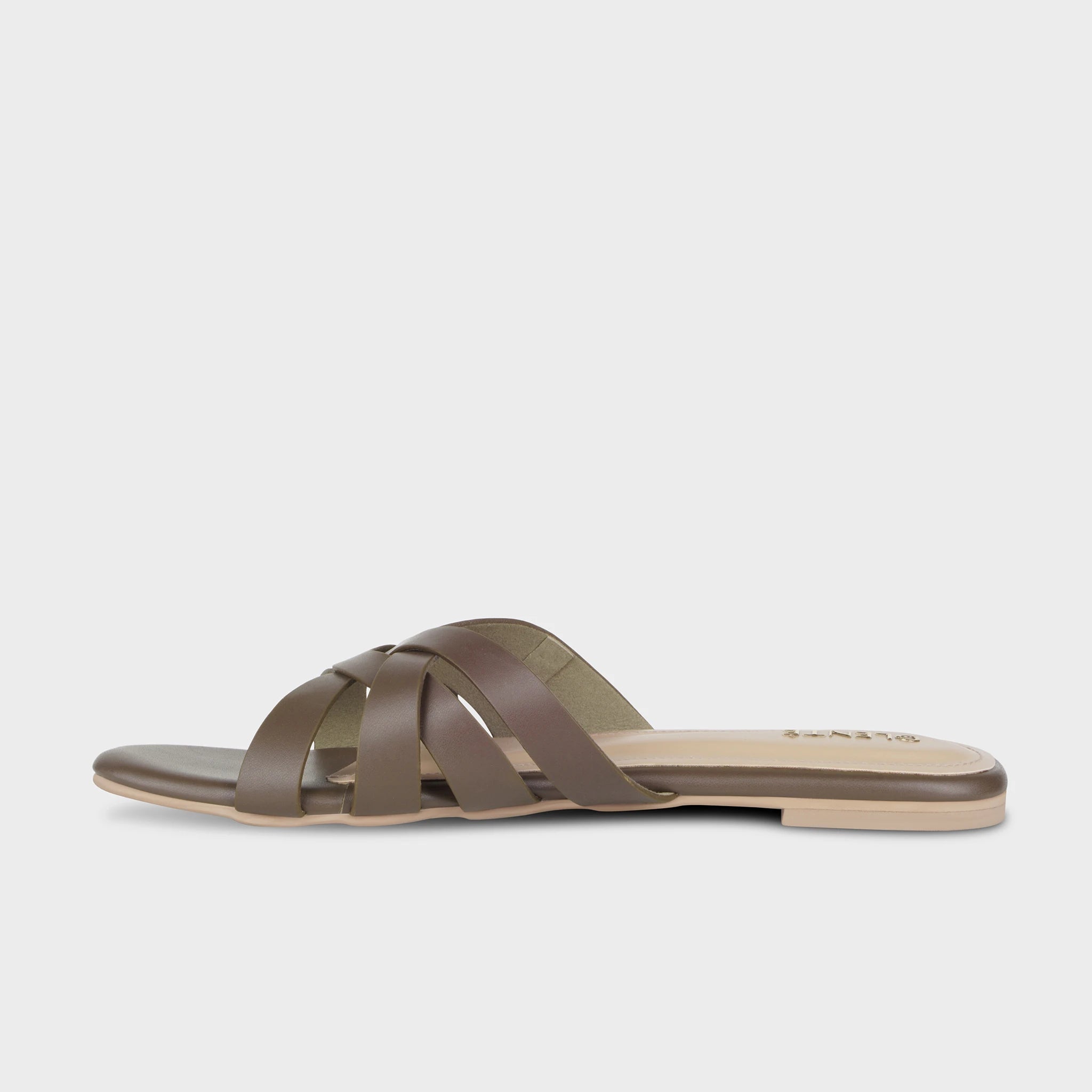 Inner side view of brown Averis flat slides showing the multi-strap woven construction, smooth matte finish, and slim nude outsole - Glentè