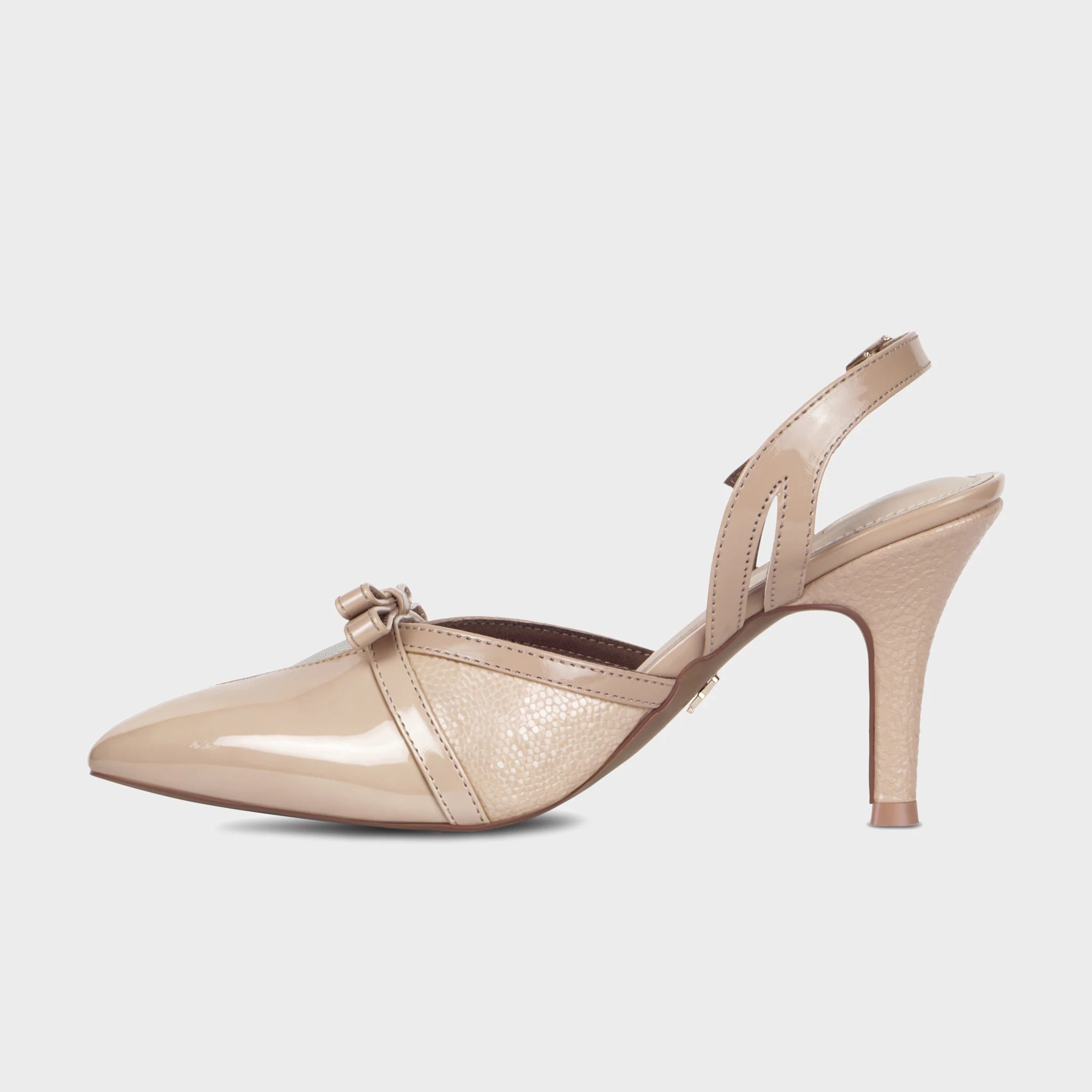 Inner side view of nude Celestrine slingback heels displaying the glossy patent pointed toe, tonal pebbled body, slim slingback strap, and textured tapered heel - Glentè