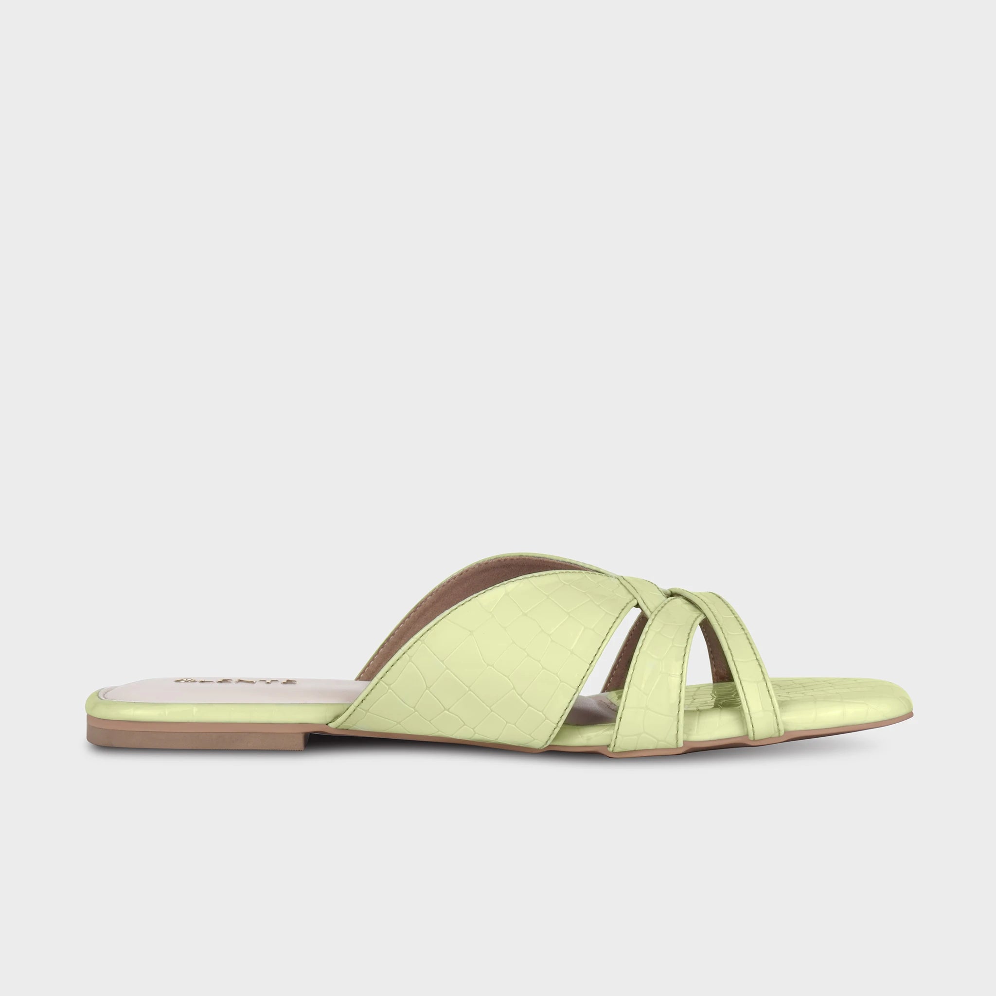 Lime green croc-embossed flat slides with interwoven crossover straps, square toe, and gold Glentè branding on a cushioned insole — Glentè Seraya