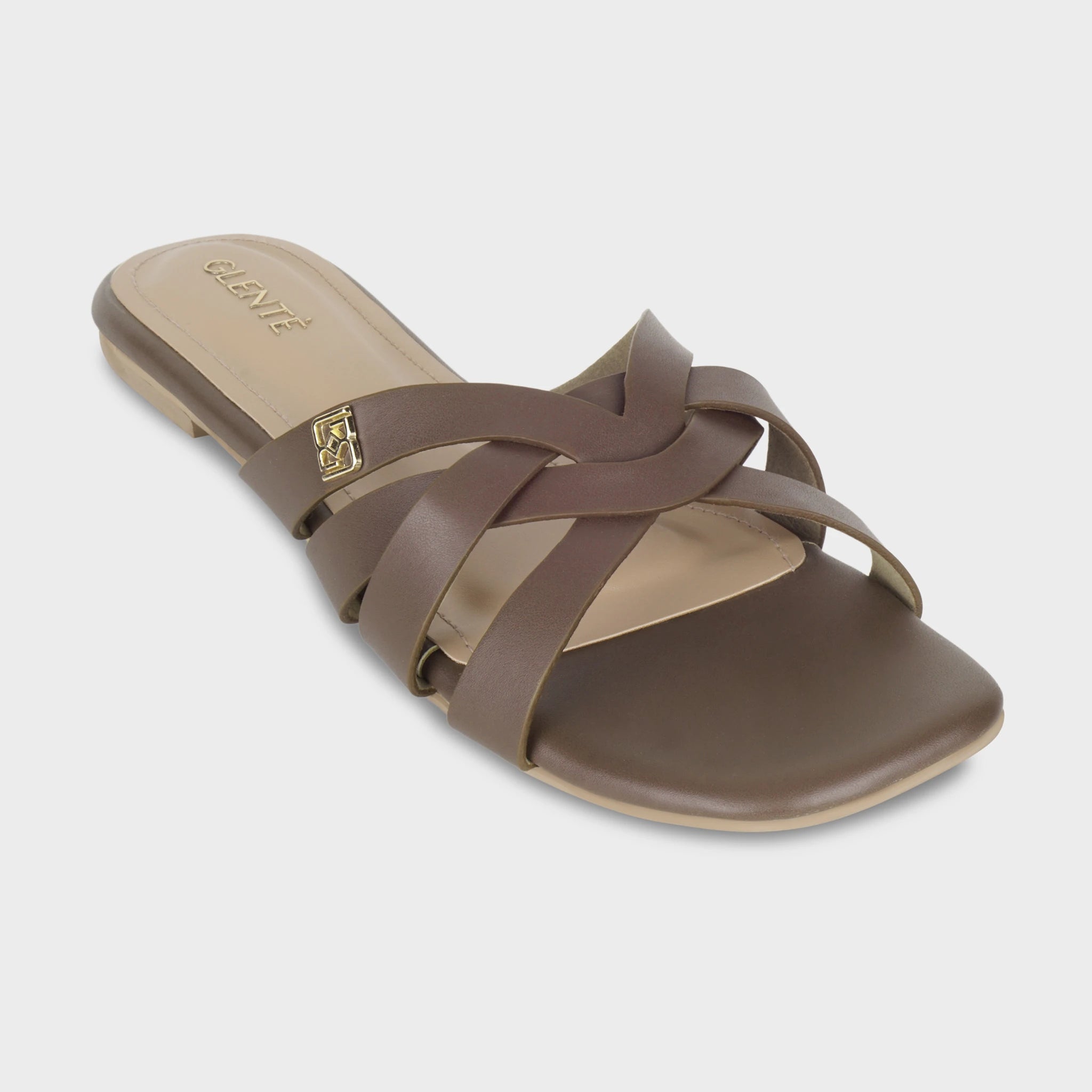 Front angled view of Averis brown flat slides highlighting the interlaced woven strap pattern, gold Glentè brand buckle, and gold branding on the insole