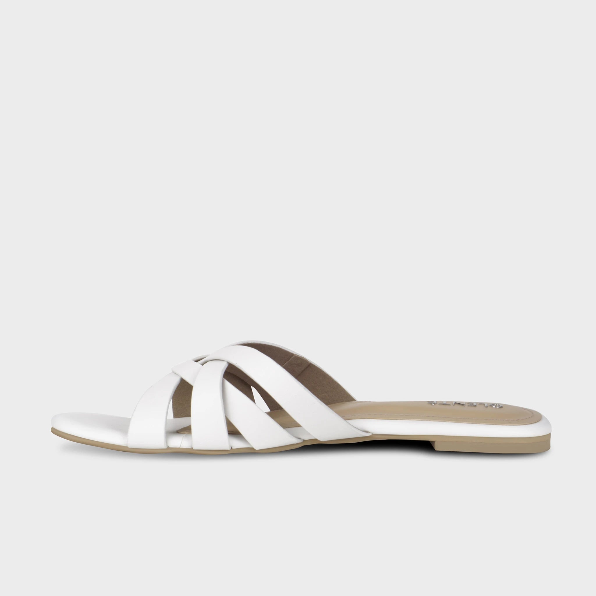 Inner side view of white Averis flat slides showing the multi-strap woven construction, clean matte finish, and slim nude outsole - Glentè
