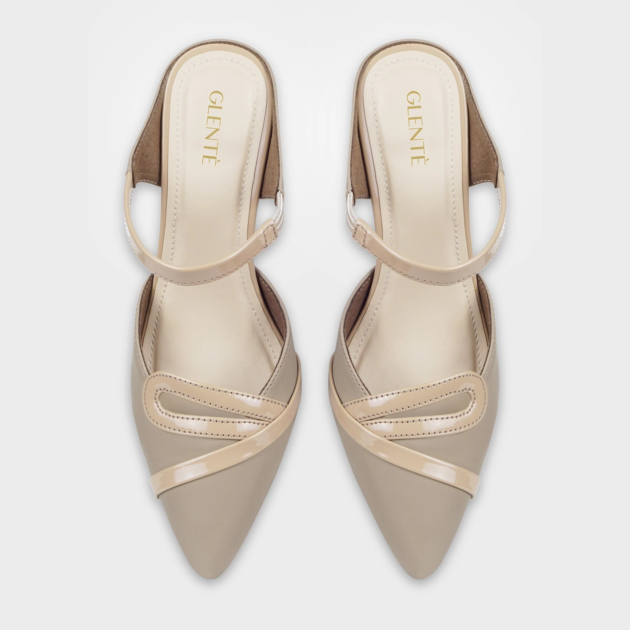 Top-down view of Eloura taupe pointed-toe heeled ankle strapped pump as a pair, showing the matching patent teardrop loop accents, diagonal glossy trim lines, slim instep straps, and gold Glentè branding on cream insoles