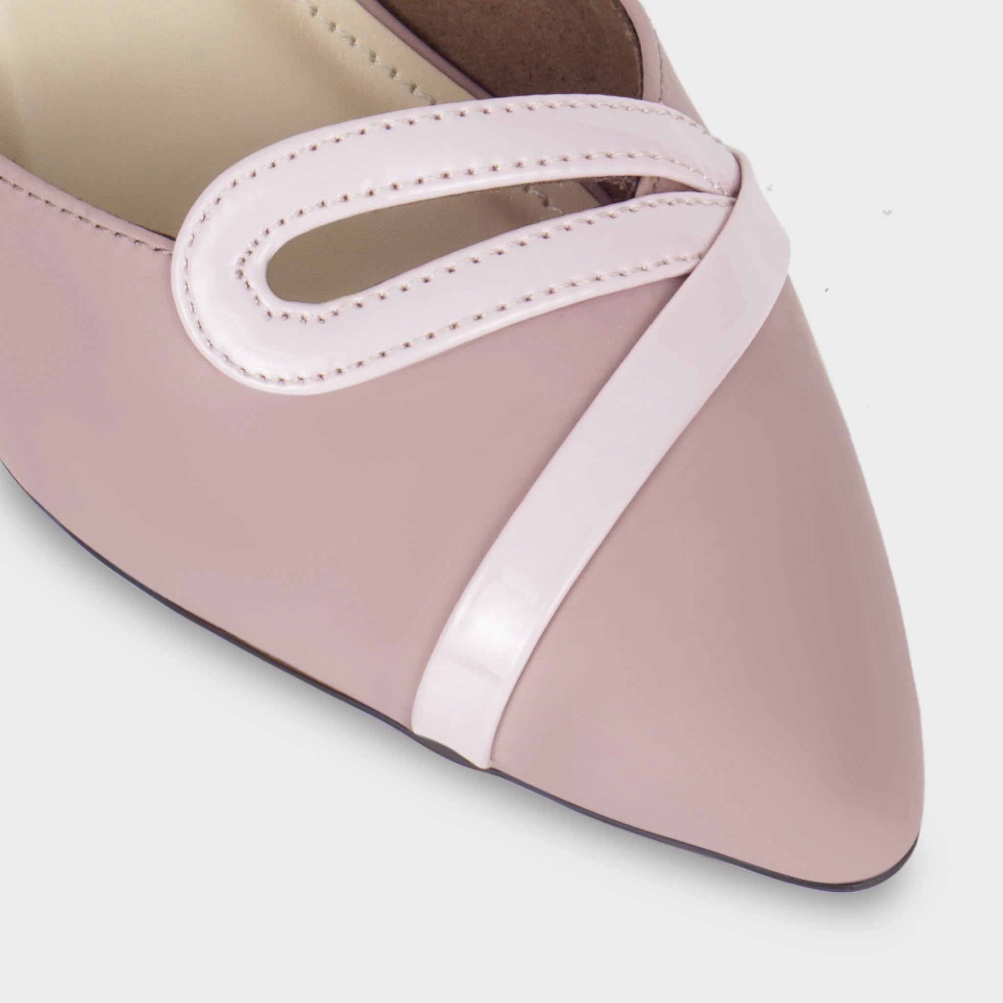 Close-up of the Eloura patent teardrop loop ornament showing the stitched open-loop construction, glossy pink trim crossing diagonally over the matte woodrose upper Glentè 