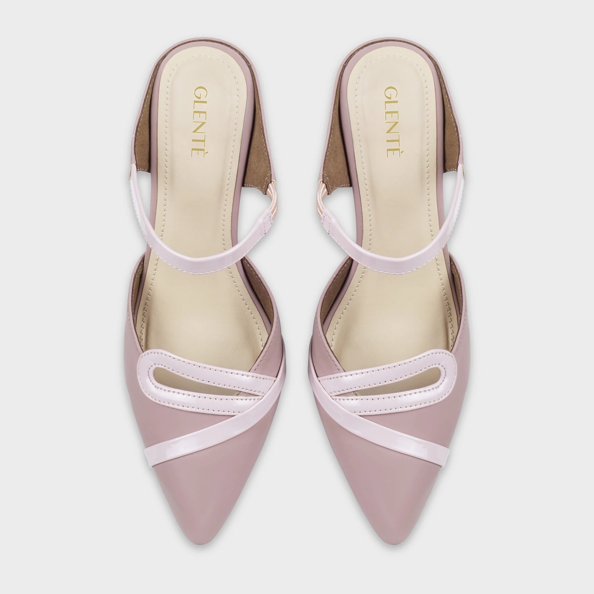 Top-down view of Eloura woodrose pointed-toe heeled ankle strapped pumpas a pair, showing the symmetrical teardrop loop accents, diagonal patent straps, slim instep bands, and gold Glentè branding on cream insoles