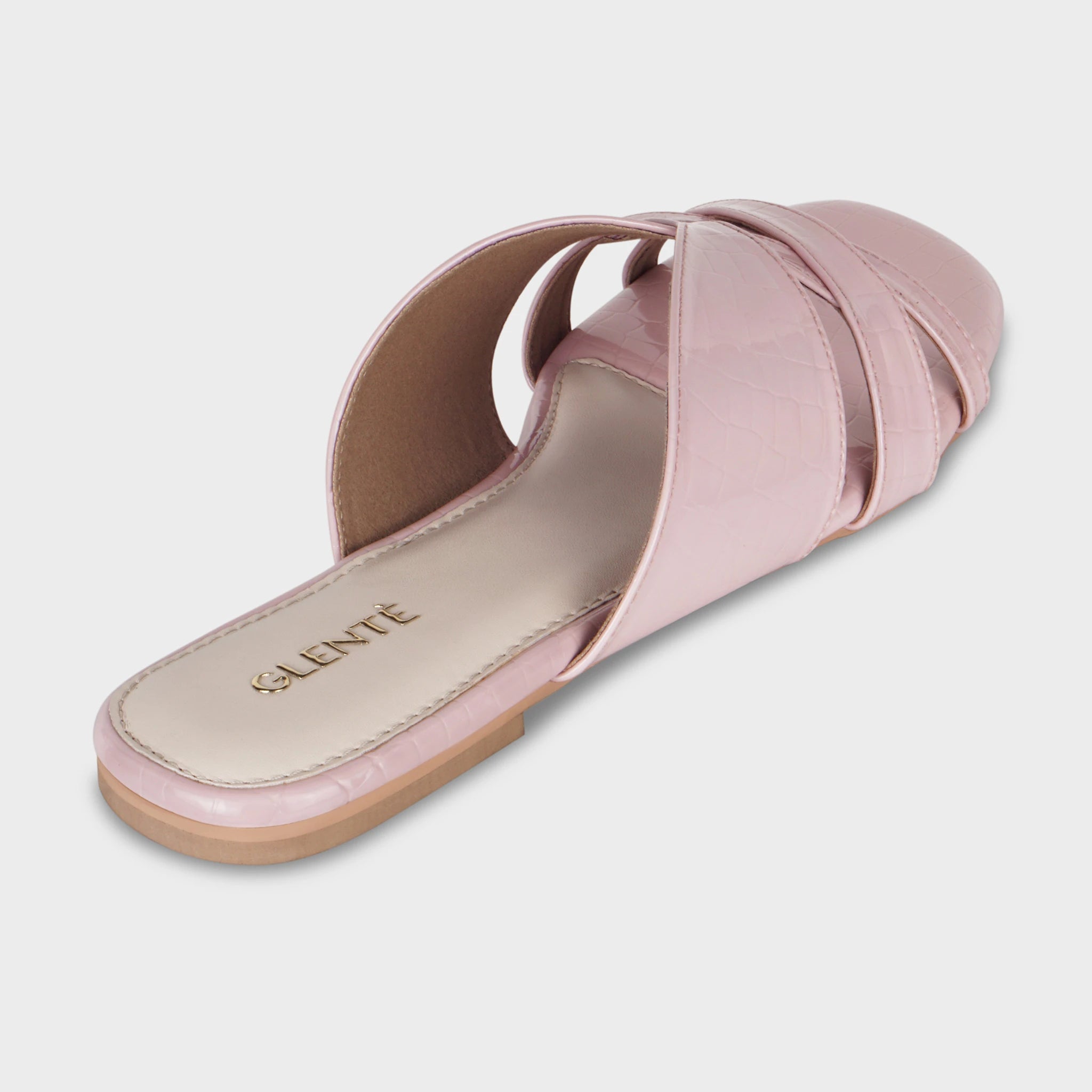 Rear angled view of Seraya pink flat slides showing the cushioned insole with embossed gold Glentè branding, croc-textured crossover straps, and tan outsole edge
