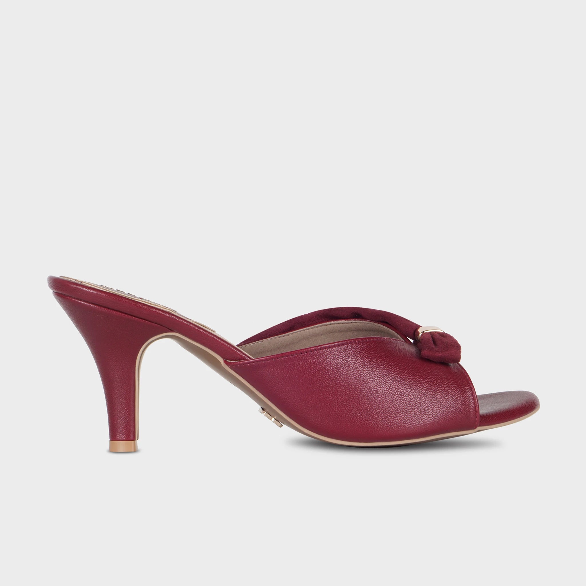 Cherry red open-toe heeled mules with a suede knotted bow accent, gold hardware clasp, and a textured spool heel — Glentè Solviane