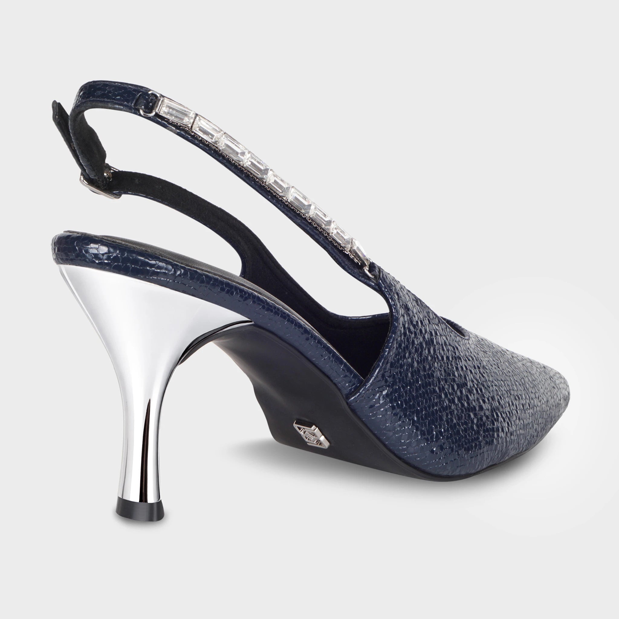 Glentè Vione navy slingback heel rear view - baguette crystal-lined slingback strap with silver buckle, high-shine chrome stiletto heel, Glentè silver logo charm on heel counter, lizard-texture upper